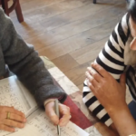 Placeholder photo: a literacy tutor and a student working together at a table.