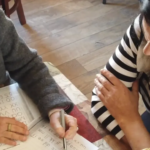Placeholder image: a tutor and a student at a table.
