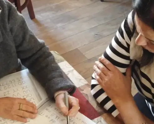 Placeholder image: a tutor and a student at a table.
